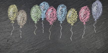 ribbon of flying balloons out of chalk on slate 