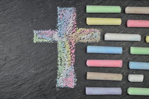 cross in sidewalk chalk on slate