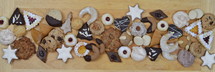 ribbon out of different kinds of Christmas cookies on a breadboard 