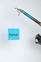 the word honor on a cyan piece of paper hanging from a fishing line 