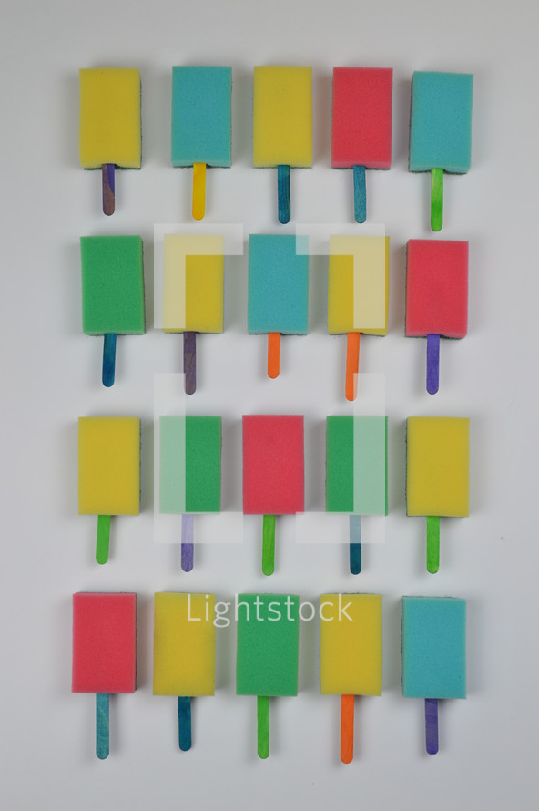 organized background pattern out of colorful self made sponge popsicles as thank you for the volunteer cleaning team in church or as decoration for the vacation bible school in the classroom