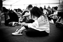 Teens sitting on the floor in prayer.