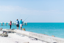 men fishing on a shore 