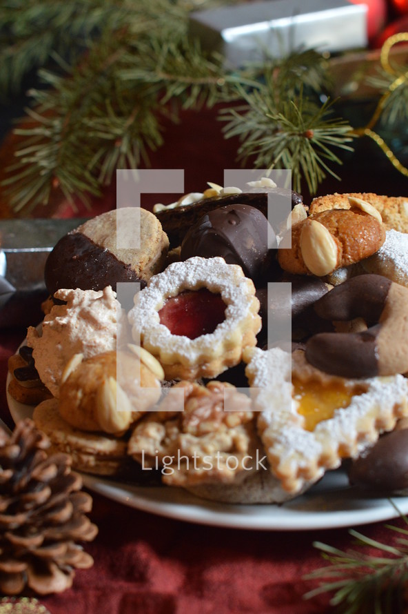christmas cookies on a plate with christmas decoration. 
Christmas, gingerbread, cookies, cookie, biscuit, delicious, tasty, yummy, delicate, colorful, colourful, multicolored, bake, baking, eating, food, bakery, bakeshop, variety, diversity, richness, nibble, snack, sweets, sweet, pastry, goods, pastries, groceries, edible, eatable, consume, cinnamon, nut, macaroons, marzipan, jam, marmalade, jelly, cooky, chocolate, nougat, choice, selection, assortment, goodies, abundance, plenty, opulence, tradition, self made, handmade, baked, fresh, sugar, icing sugar, powdered sugar, dough, breadboard, bread-board, bread board, biscuits, almond, season, Christmas time, Christmastide, cut out, butter, cut, vanilla crescents, heart, hearts, fir tree, fir trees, walnut, hazelnut, coconut, advent, sharing, friend, friends, hand, hands, take, taking, different, various, divergent, diverse, varied, differing, variable, shape, shapes, kind, sort, plate, give, giving, present, offer, offering, hospitality, invitation, party, joy, celebration, eat, festivity, guest, guests, guest-friendship, invite, see, come, visit, gift, homemade, home made, home-made, self, self-made, celebrate, celebrating, feast, enjoy, relish, savor, savour, appreciate, pick, help oneself, help yourself, empty, full, prepare, preparing, dress, dressing, serve, serving, food arrangement, arrange, arranging, decorate, decorating
