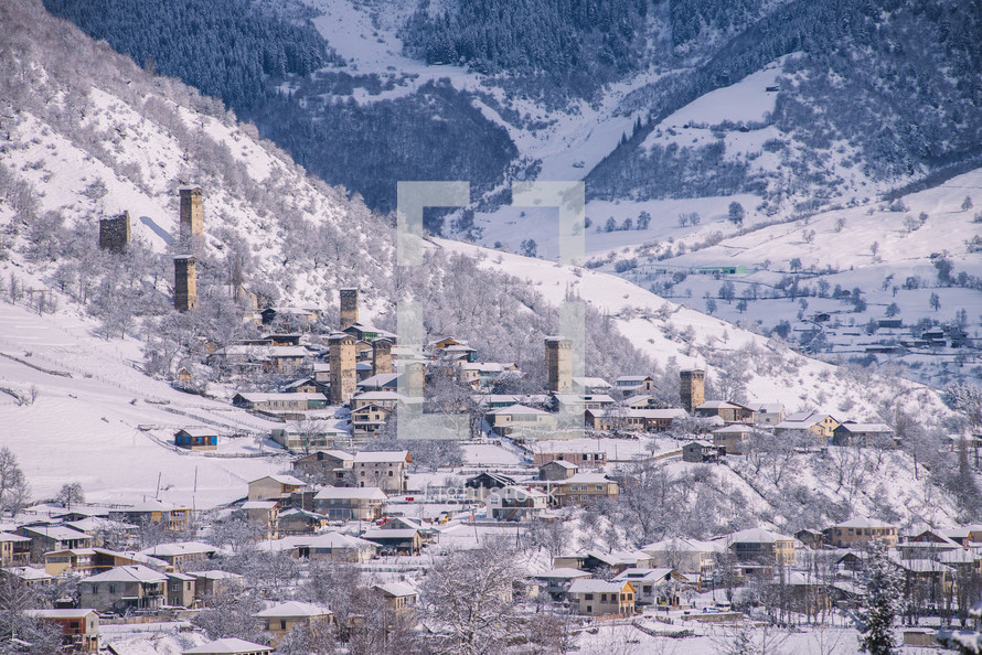 Snowy stone towers in a mountain village