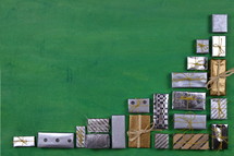 many little silver and golden presents building a border on green wooden background