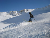 a little six years old boy jumping on his ski, 