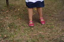 toddler girl with dirty shoes 
