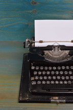 vintage typewriter on teal wooden desk