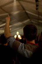Man with finger raised during a worship service.