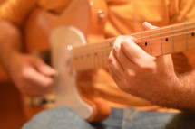 man playing an electric guitar.
