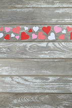 paper hearts on a weathered wood background 