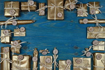 Frame of advent calendar with twenty four golden presents on teal wood