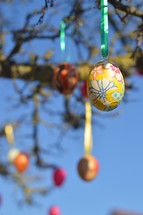 Easter eggs hanging on tree branches 
