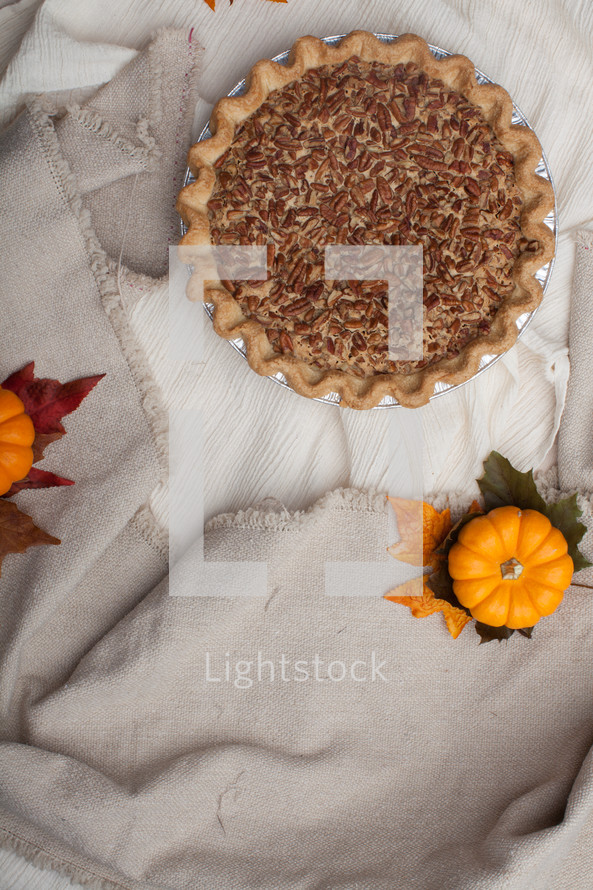 a pecan pie on a tablecloth 
