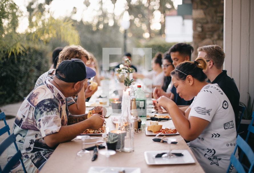 people eating at a dinner party 