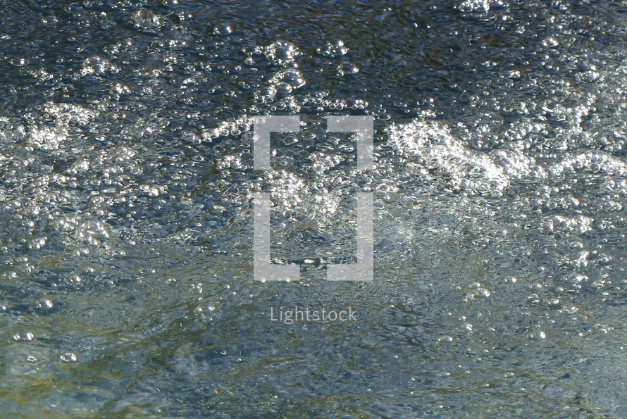 water surface with sparkling reflections of sunlight