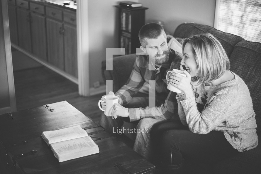 couple drinking coffee and reading a Bible 