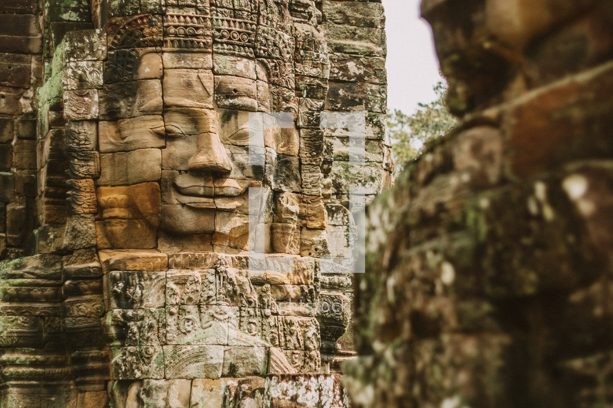face carved in stone in temple ruins in Cambodia 