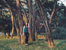 woman posing standing in front of a tree outdoors 