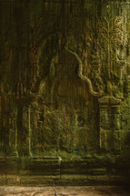 carvings in the walls of a temple in ruins in Cambodia 