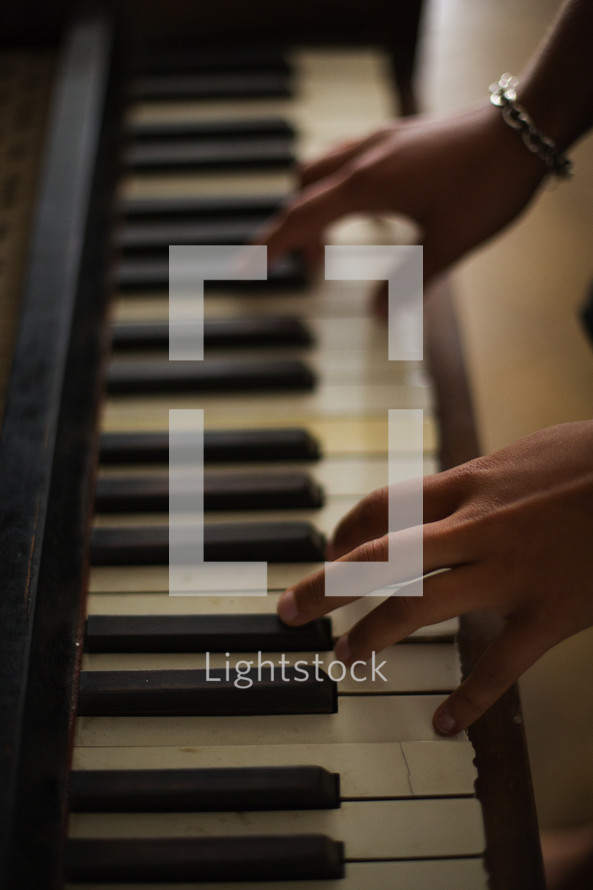 hands on the keys of a piano 