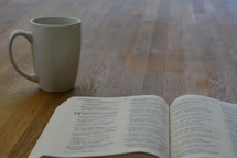 mug and open Bible 