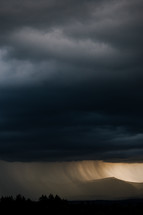 Thunderstorm over mountains with rain fall