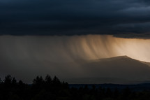 Thunderstorm over mountains with rain fall