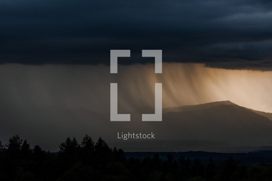 Thunderstorm over mountains with rain fall