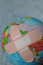 bandaids on a globe - healing the world
