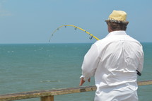 man fishing on a pier 