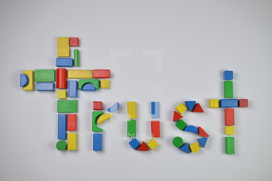 cross and word trust of colorful toy wooden blocks 