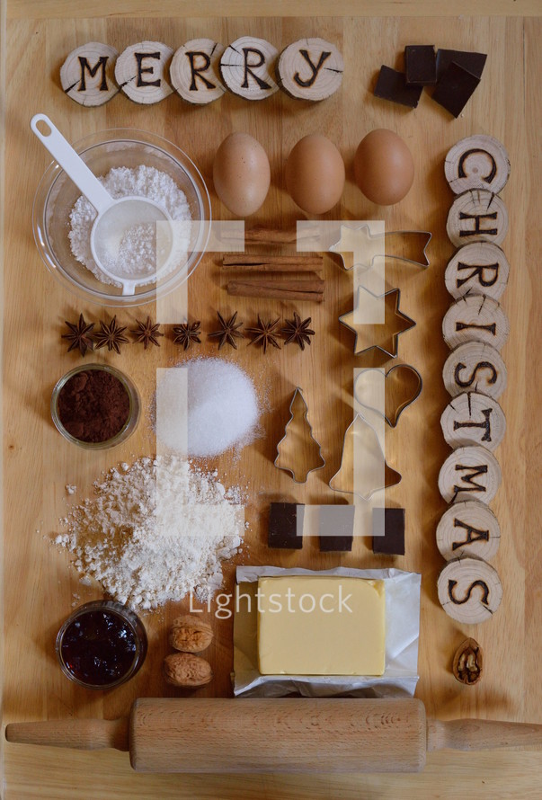 Baking ingredients with wooden pieces and the words MERRY CHRISTMAS burned into them 