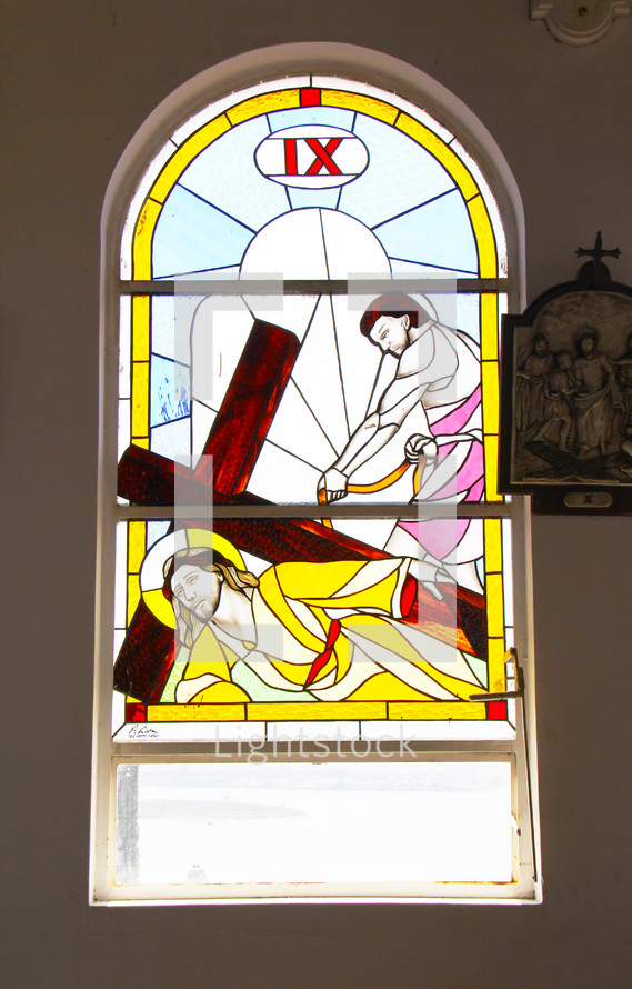 Stained glass windows depicting Stations of the Cross. Number 9.