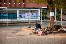 A man repairing his bicycle tire. 