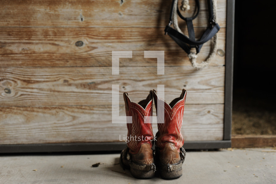 cowboy boots on a stable floor 