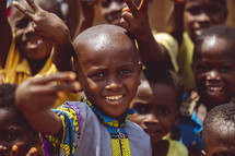 African smiling, laughing children waving hello  in a small village church in the Ivory Coast in west Africa