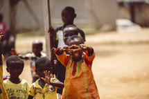 African smiling, laughing children giving a peace sign  in a small village church in the Ivory Coast in west Africa