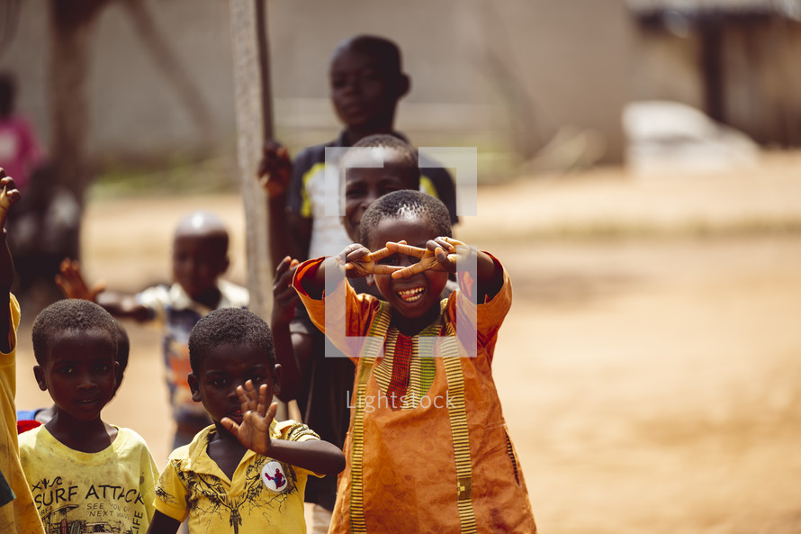 African smiling, laughing children giving a peace sign  in a small village church in the Ivory Coast in west Africa