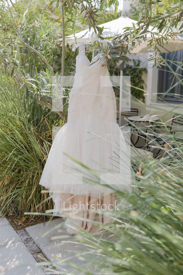 wedding gown hanging outdoors 