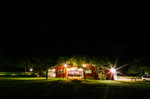 A red barn at night used for an outdoor wedding reception. 