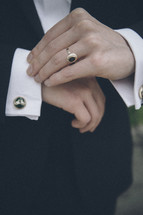 groom fastening his buttons