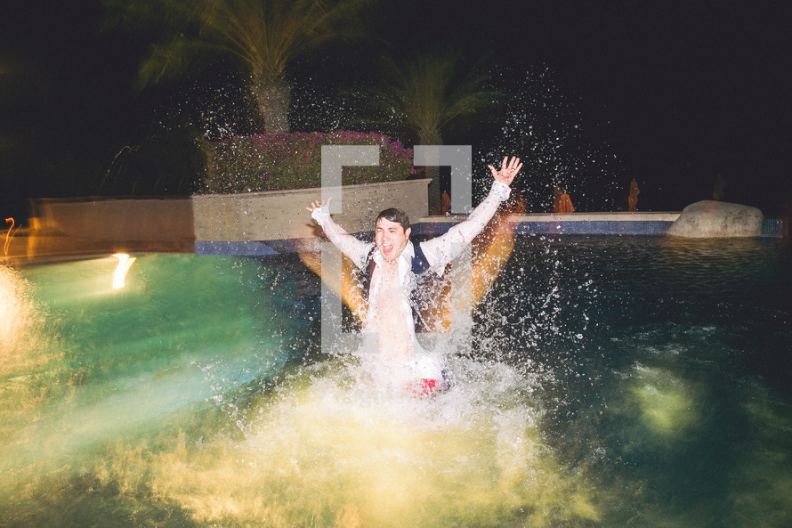 groomsmen in a tuxedo splashing in a pool 