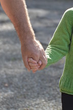 father and daughter holding hands 