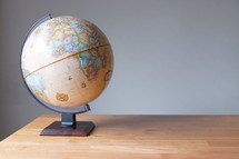 globe on a wood desk 