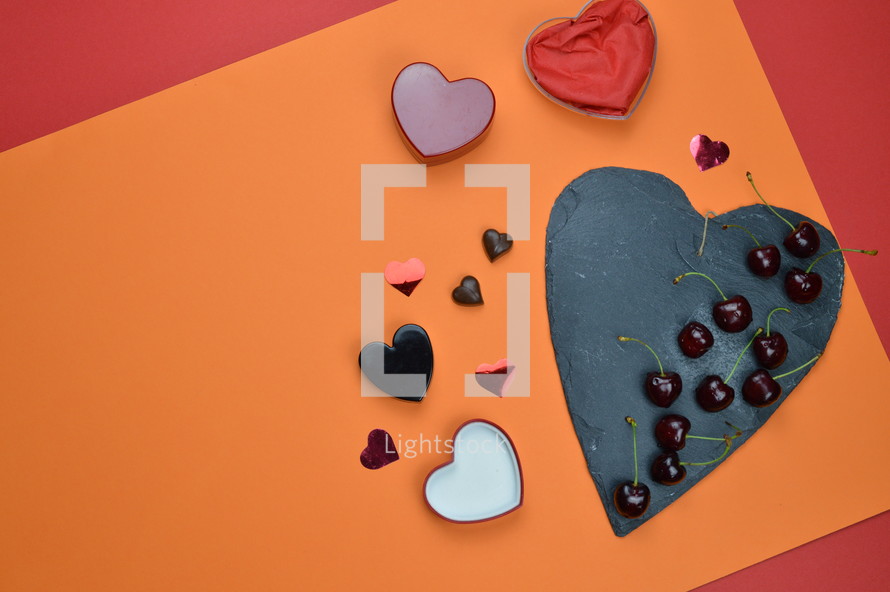 hearts shapes, cherries, colored paper, and slate 