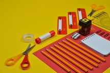 office supplies on red and yellow 