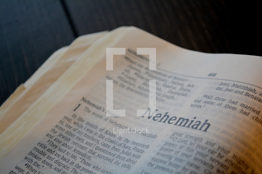 A Bible opened to the book of Nehemiah.
