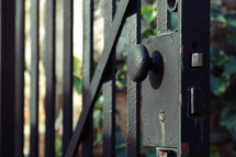 Metal gate handle and lock.